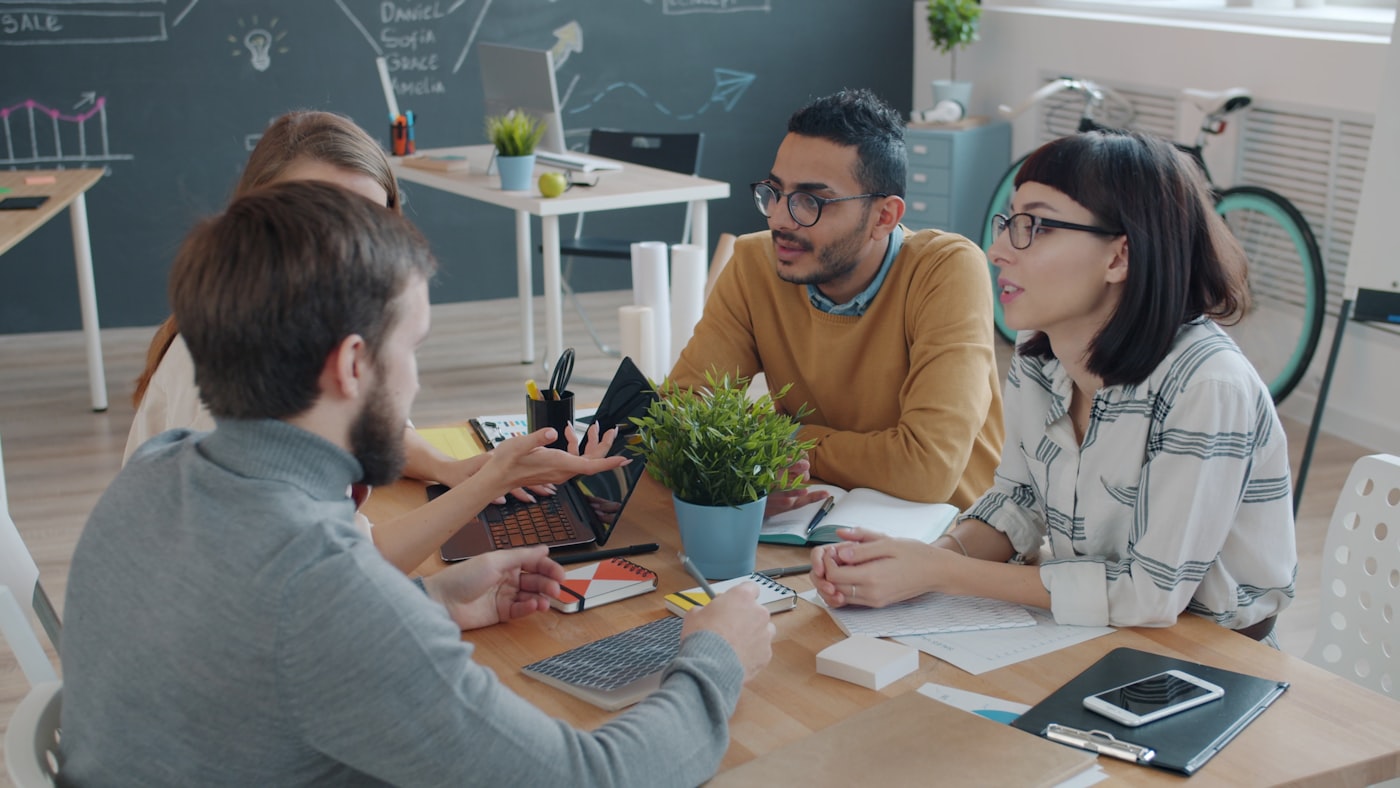 Diverse team collaborating around a table in a modern office